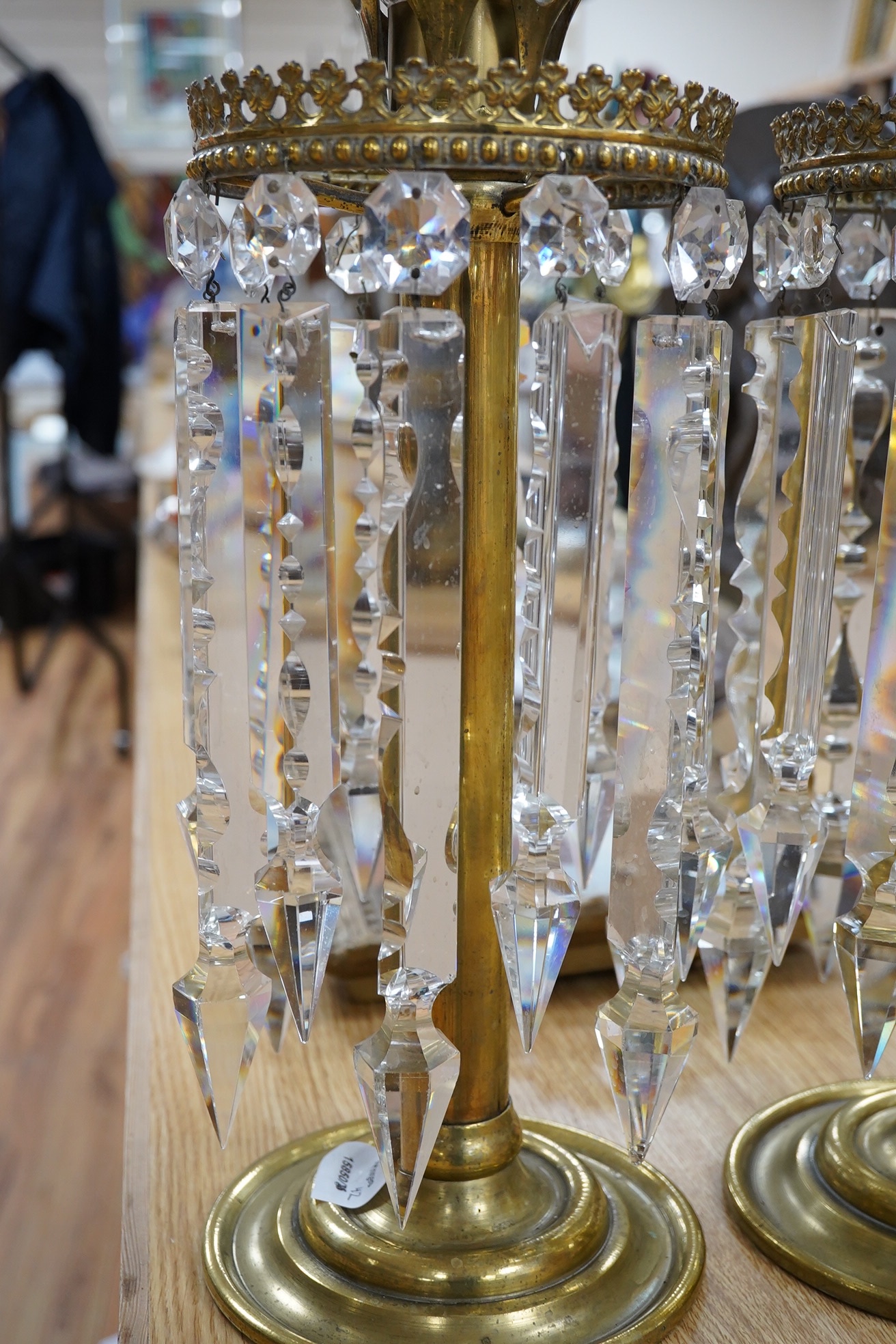 A pair of brass table lustres with storm shades, overall 63cm high, drops 21/26cm long. Condition- good